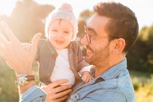 Photo of a middle-aged male holding a baby