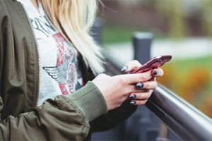 Photo of a person holding a smartphone