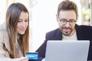 Photo of a female and buy shopping on a laptop