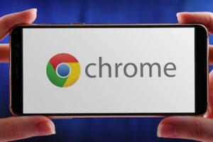 Photo of a smartphone with Chrome logo on the screen