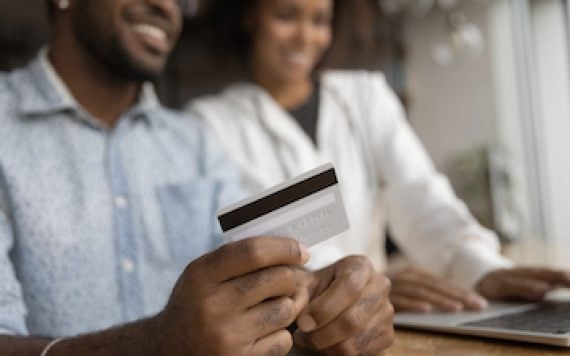 Photo of male and female in front of a computer shopping