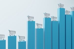 Consumer price index and basket goods concept with front view on metallic shopping trolleys on tops of growing financial chart graph pillars on abstract light background. 3D rendering