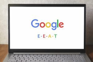 Laptop screen with Google logo and the letters "E - E- A - T"