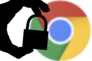 Hand holding lock over Google Chrome logo