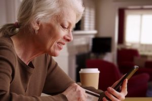 Image of an older female shopping on a smartphone