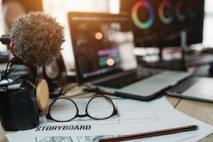 Photo of a creator's desk with computer, camera, mic