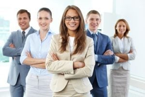 Portrait of five businesspeople looking at camera with female leader in front