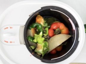 Image of a Lomi composter full of leftover fruits and vegetables.