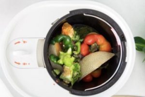 Image of a Lomi composter full of leftover fruits and vegetables.