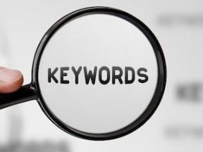 Image of a magnifying glass with "keywords" behind it