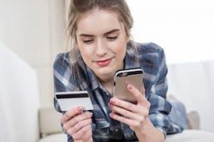 Image of a female using a credit card for an online purhcase on a smartphone