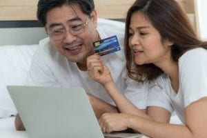 Screenshot of middle-aged couple in front of a laptop