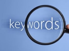 Illustration of a magnifying glass with the word "keywords" behind it