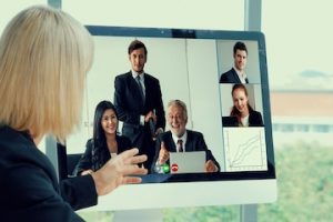 A female looking at a computer during a video event