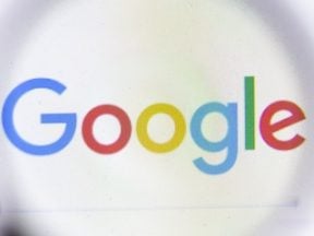 Google logo behind a magnifying glass