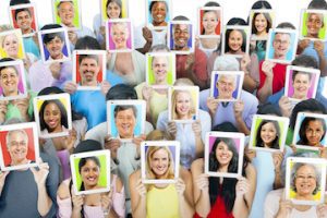 Photo of dozens of people holding images of themselves