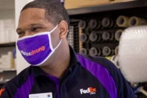 Screenshot from HappyReturns.com showing a FedEx exmployee recieving a returned item