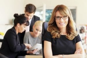 Photo of a female with staff in a business setting