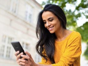 Photo from Mastercard's site of a female looking at a smartphone