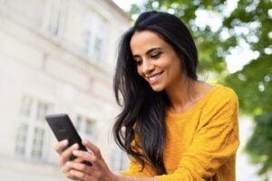 Photo from Mastercard's site of a female looking at a smartphone